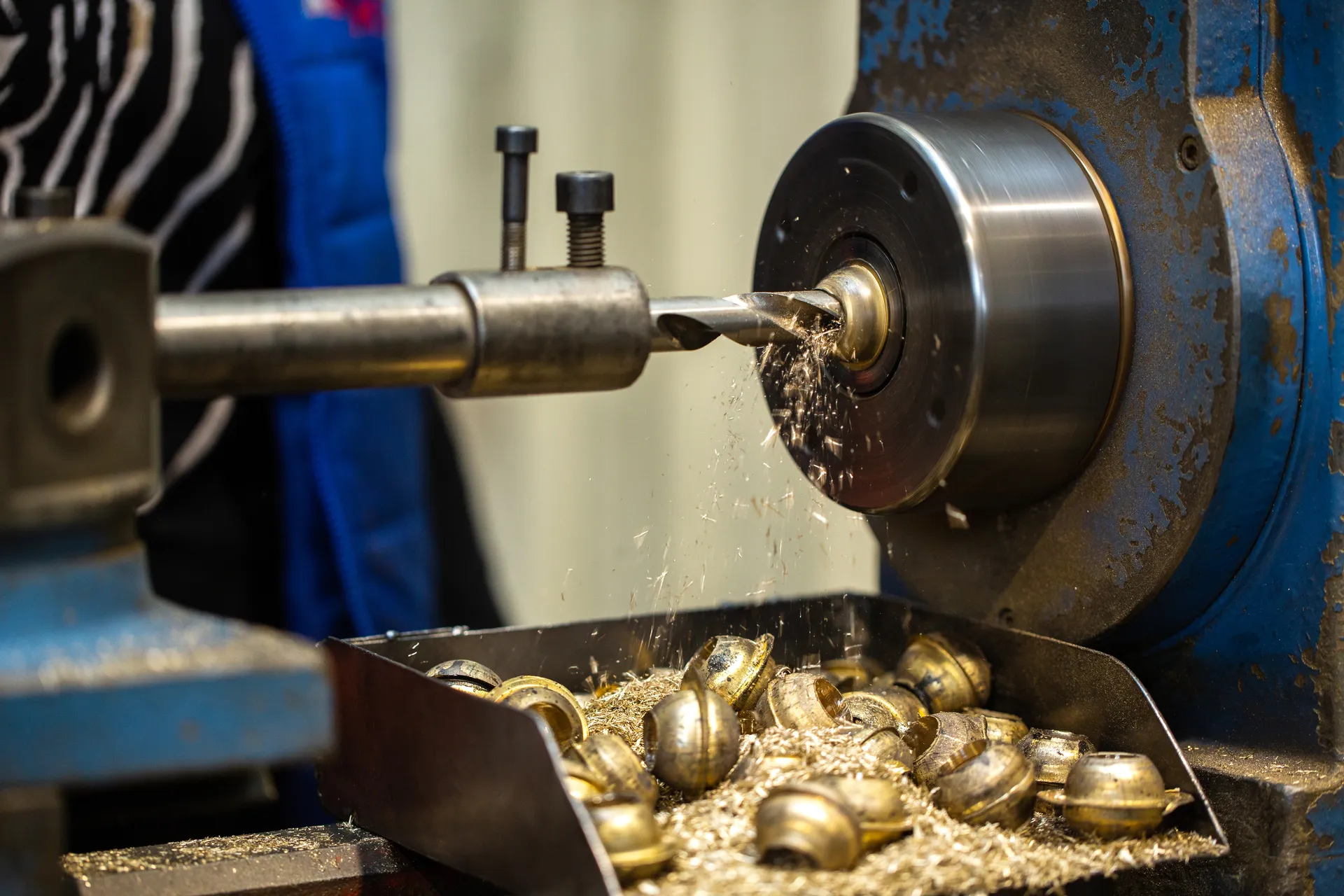 Close-up of precision brass pieces being machined on a lathe