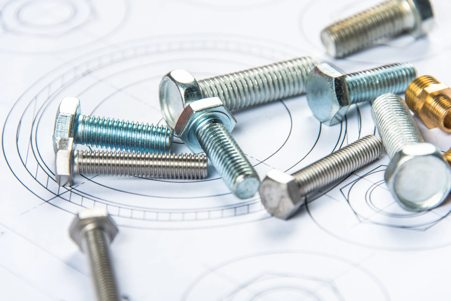 Hex bolts and fasteners laid out on a blueprint
